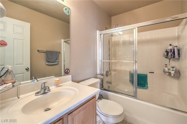 bathroom featuring toilet, shower / bath combination with glass door, and vanity