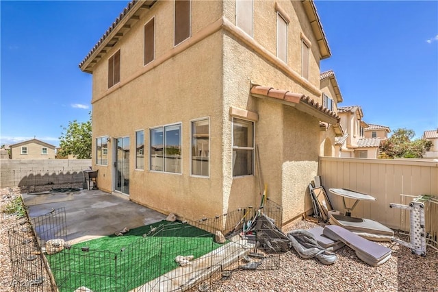 exterior space featuring a fenced backyard, a patio area, and stucco siding