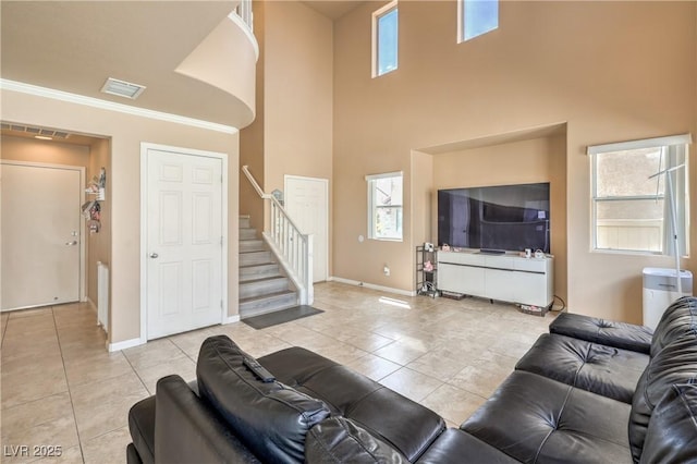 living room featuring light tile patterned flooring, baseboards, visible vents, and stairway