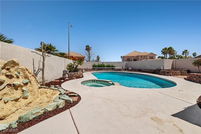 view of swimming pool with a fenced backyard, a patio area, and a pool with connected hot tub