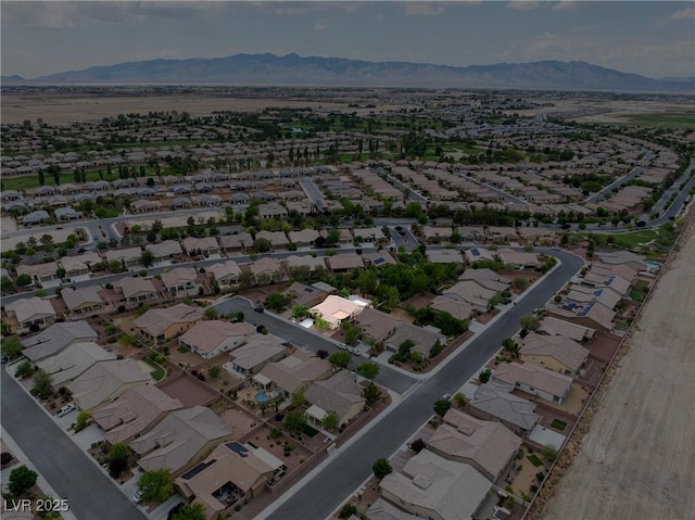 birds eye view of property with a mountain view and a residential view