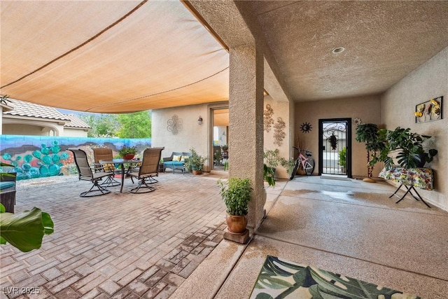 view of patio with fence and outdoor dining space
