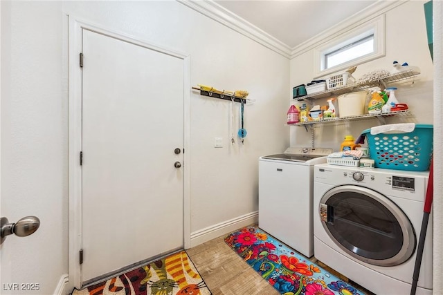 laundry room featuring laundry area, ornamental molding, baseboards, light wood-type flooring, and independent washer and dryer