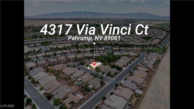 drone / aerial view with a residential view and a mountain view