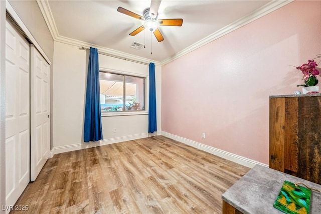 unfurnished bedroom with visible vents, wood finished floors, baseboards, a closet, and ornamental molding