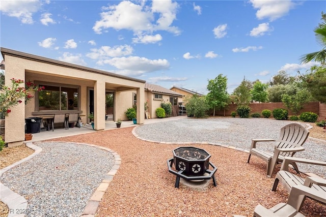 view of yard with a fire pit, a patio area, and fence