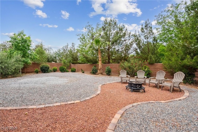 view of yard featuring a fenced backyard, a patio area, and an outdoor fire pit