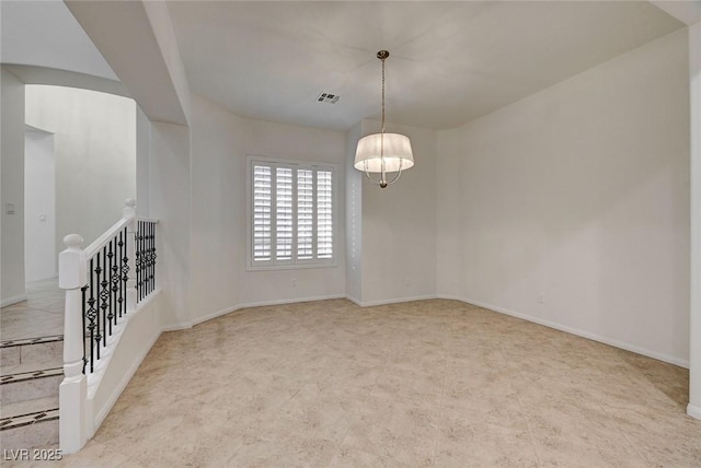 unfurnished room with an inviting chandelier, baseboards, and visible vents