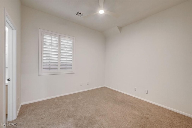 carpeted empty room featuring baseboards, ceiling fan, and visible vents