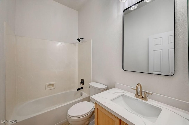 bathroom featuring vanity, bathtub / shower combination, and toilet