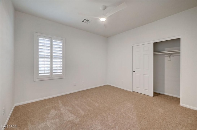 unfurnished bedroom with visible vents, carpet flooring, baseboards, and a closet