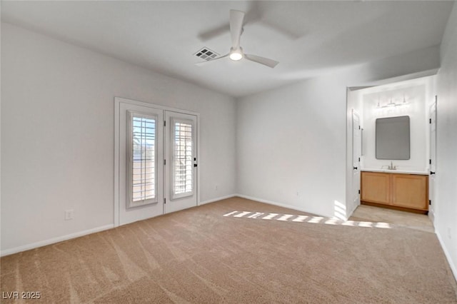 interior space featuring baseboards, light colored carpet, and visible vents