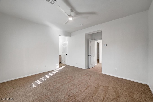 empty room with ceiling fan, visible vents, baseboards, and carpet
