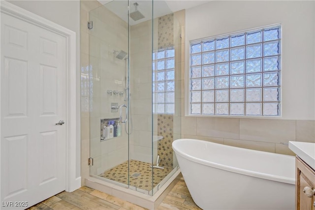 11249 Revelry Ln, Las Vegas, NV 89138 - bathroom featuring visible vents, a shower stall, wood finished floors, vanity, and a soaking tub
