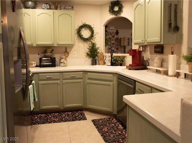 2050 W Warm Springs Rd Unit 411, Henderson, NV 89014 - kitchen with light countertops, arched walkways, appliances with stainless steel finishes, and light tile patterned floors