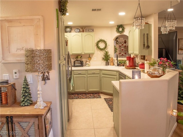 2050 W Warm Springs Rd Unit 411, Henderson, NV 89014 - kitchen with visible vents, a peninsula, light tile patterned flooring, arched walkways, and a sink