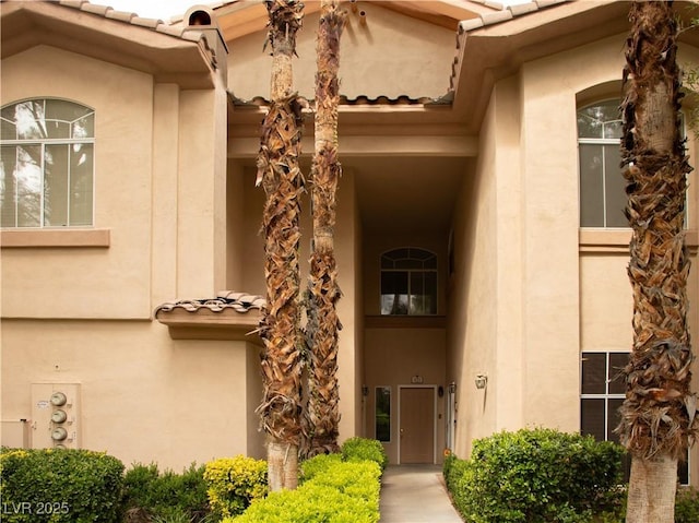 2050 W Warm Springs Rd Unit 411, Henderson, NV 89014 - doorway to property featuring a tile roof and stucco siding
