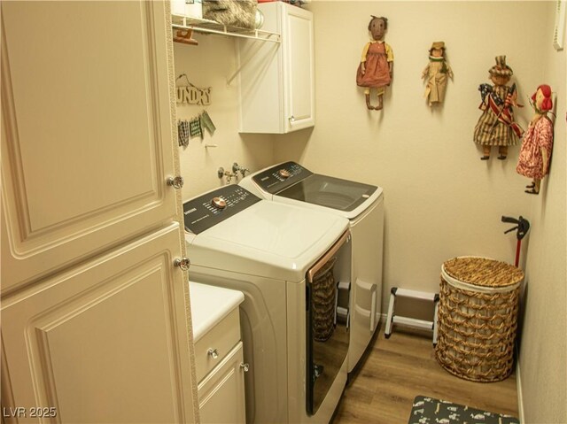 2050 W Warm Springs Rd Unit 411, Henderson, NV 89014 - laundry area featuring cabinet space, independent washer and dryer, and wood finished floors