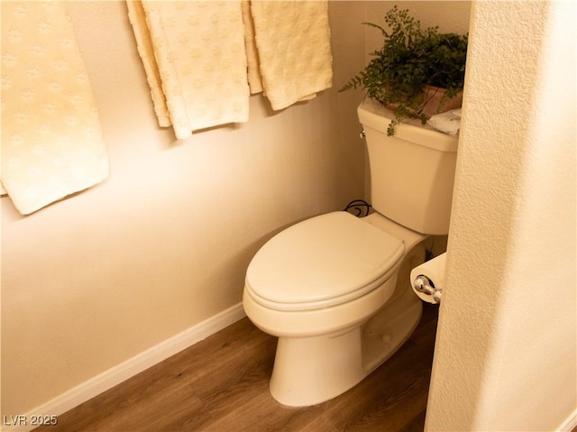2050 W Warm Springs Rd Unit 411, Henderson, NV 89014 - bathroom featuring baseboards, wood finished floors, and toilet