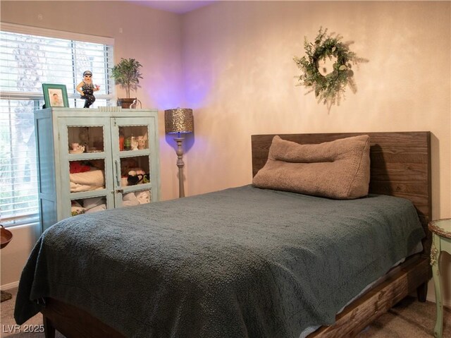 2050 W Warm Springs Rd Unit 411, Henderson, NV 89014 - bedroom with baseboards and carpet
