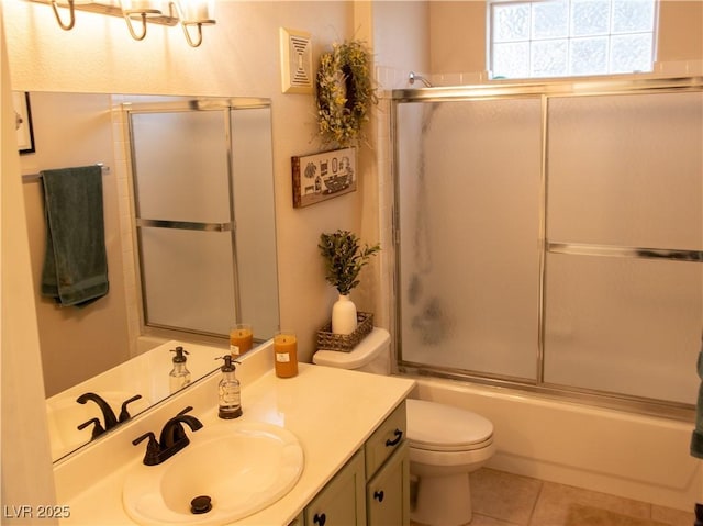 2050 W Warm Springs Rd Unit 411, Henderson, NV 89014 - bathroom with vanity, tile patterned flooring, toilet, and shower / bath combination with glass door