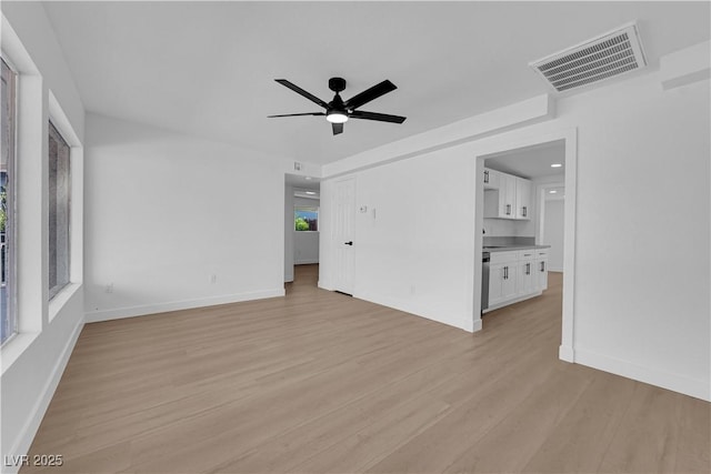 unfurnished living room with visible vents, baseboards, ceiling fan, and light wood-type flooring