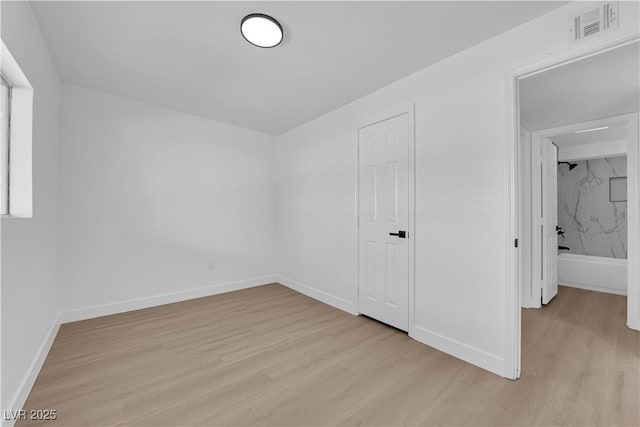 unfurnished bedroom with baseboards, visible vents, and light wood-style flooring