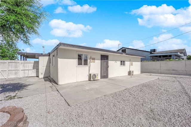 back of house featuring a patio, a fenced backyard, and ac unit