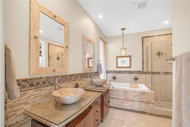 full bathroom with visible vents, a sink, and a stall shower