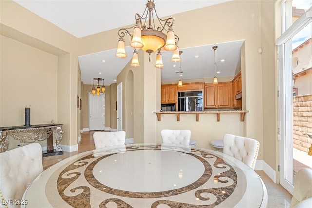 dining space featuring recessed lighting, baseboards, and a notable chandelier