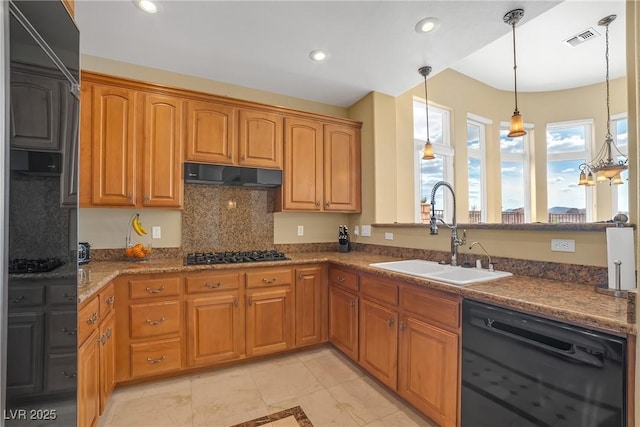 kitchen featuring visible vents, black dishwasher, gas stovetop, under cabinet range hood, and a sink
