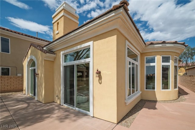 32 Cerchio Basso, Henderson, NV 89011 - view of property exterior with a patio area, stucco siding, and a chimney