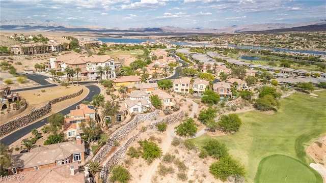 drone / aerial view featuring a residential view, view of golf course, and a water and mountain view