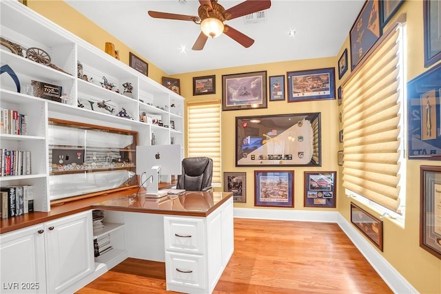 office space with baseboards, light wood finished floors, and ceiling fan