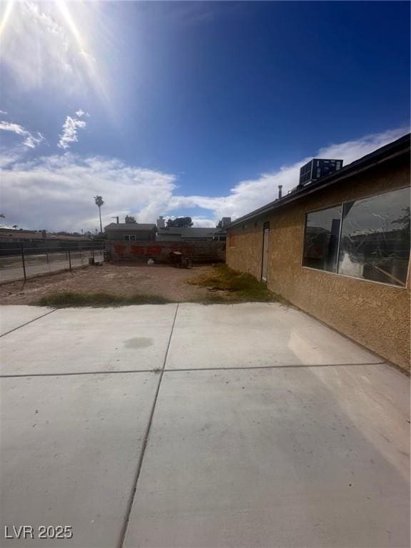 view of yard featuring a patio, central AC unit, and fence