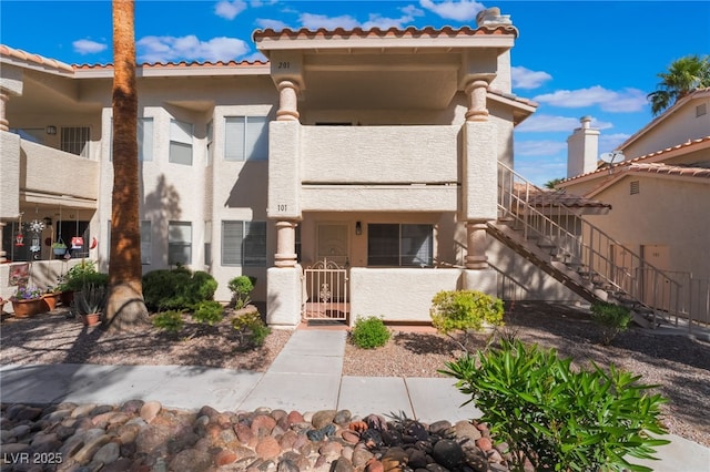912 Falconhead Ln Unit 101, Las Vegas, NV 89128 - view of front of home with fence private yard, a tile roof, and stucco siding