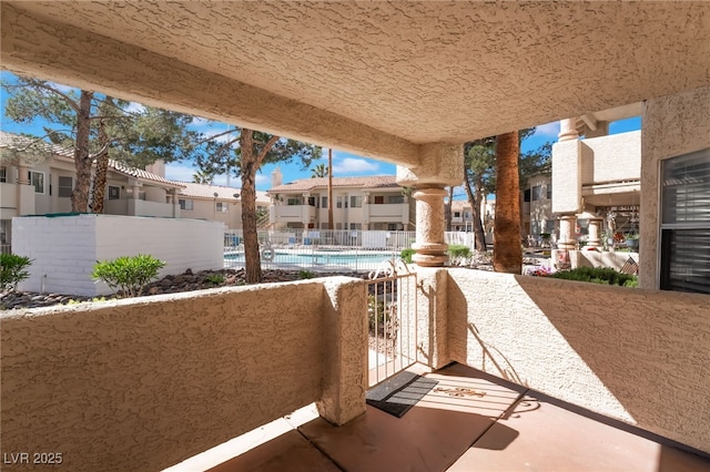 912 Falconhead Ln Unit 101, Las Vegas, NV 89128 - view of patio with a community pool, fence, and a residential view
