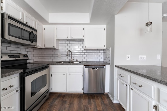 912 Falconhead Ln Unit 101, Las Vegas, NV 89128 - kitchen with a sink, appliances with stainless steel finishes, decorative backsplash, and white cabinetry