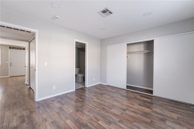 912 Falconhead Ln Unit 101, Las Vegas, NV 89128 - unfurnished bedroom featuring visible vents, baseboards, wood finished floors, and a closet