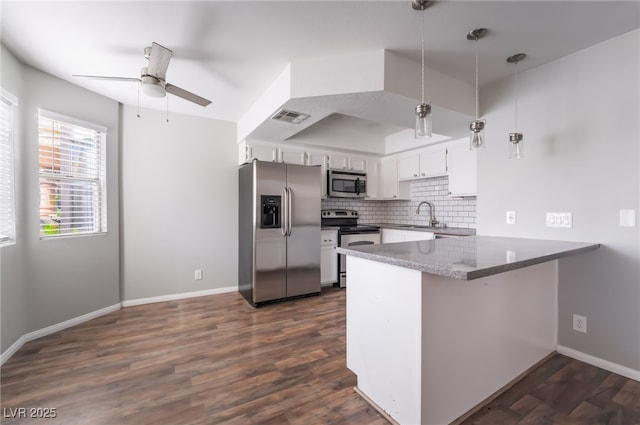 912 Falconhead Ln Unit 101, Las Vegas, NV 89128 - kitchen featuring stainless steel appliances, a ceiling fan, a peninsula, backsplash, and visible vents