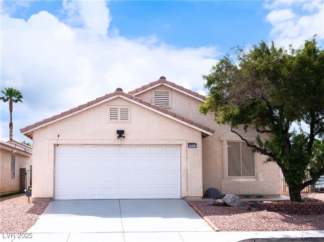view of front of house featuring a garage, stucco siding, concrete driveway, and a tiled roof