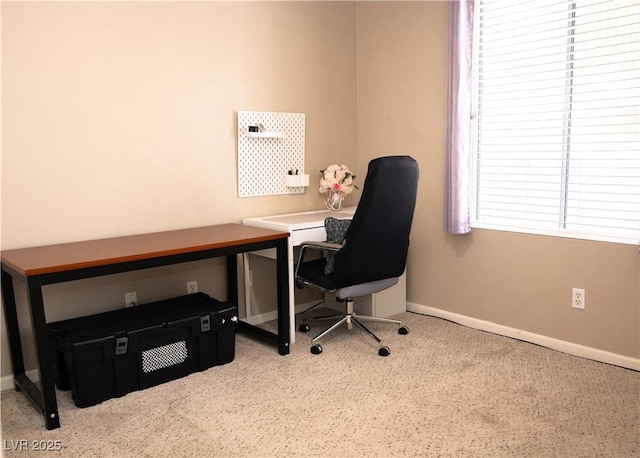 carpeted office space with baseboards