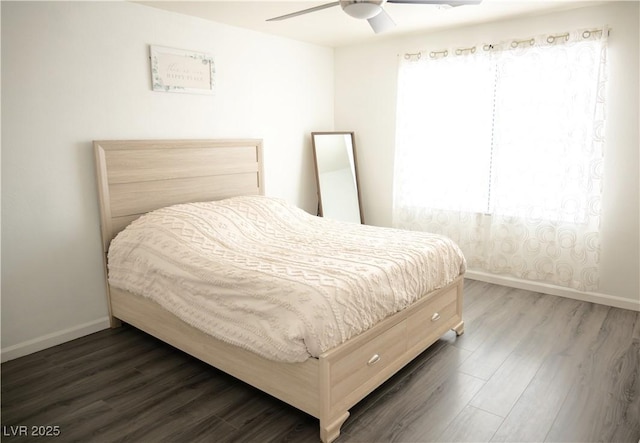 bedroom with a ceiling fan, baseboards, and dark wood finished floors