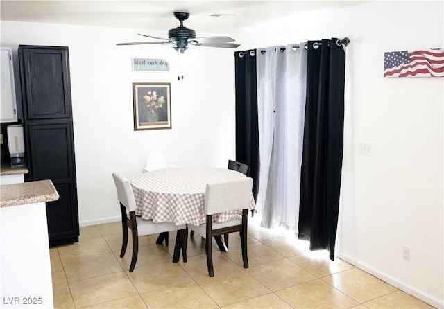 dining space featuring light tile patterned floors, baseboards, and a ceiling fan