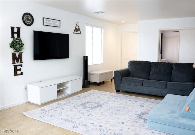 living area featuring light tile patterned flooring, baseboards, and visible vents