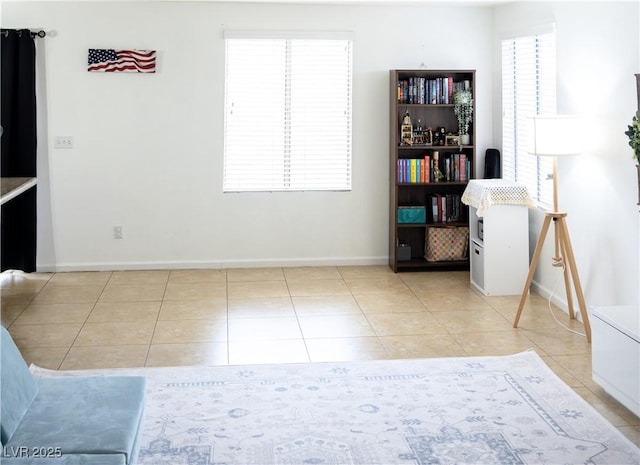 dining area with baseboards and light tile patterned flooring