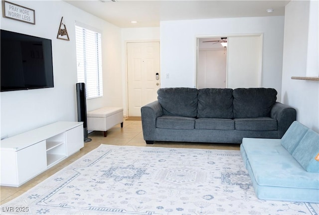 living room featuring a ceiling fan and light tile patterned flooring