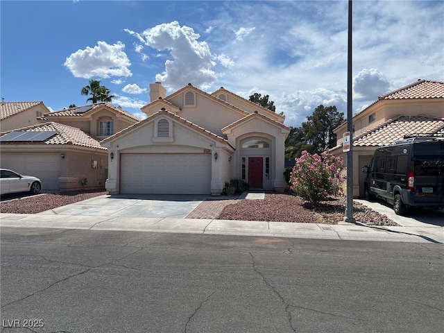 1249 Lucia Dr, Las Vegas, NV 89128 - mediterranean / spanish house featuring a garage, stucco siding, and driveway