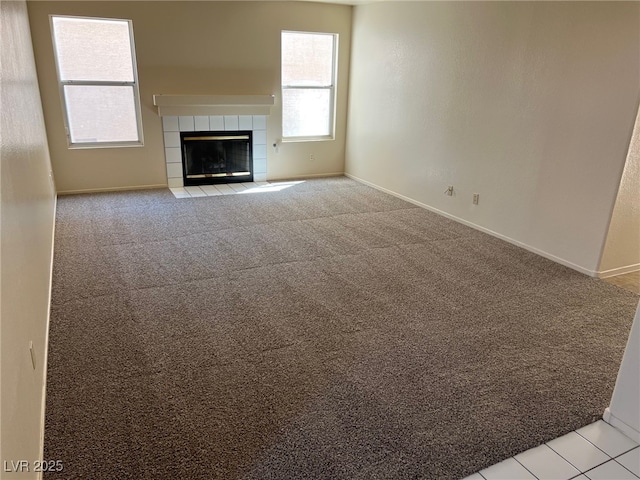 1249 Lucia Dr, Las Vegas, NV 89128 - unfurnished living room with baseboards, light carpet, and a fireplace