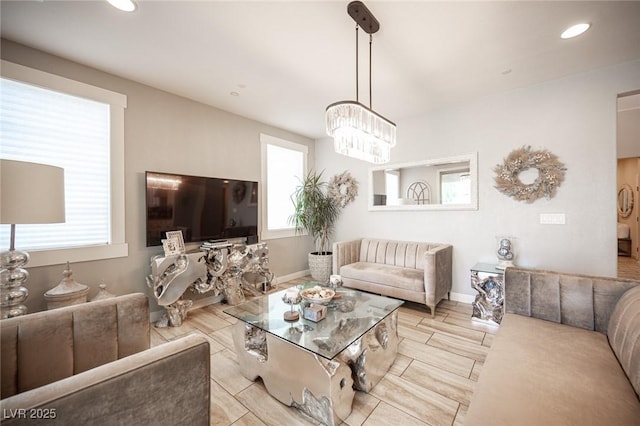 2198 Maderno St, Henderson, NV 89044 - living room with recessed lighting, baseboards, a healthy amount of sunlight, and an inviting chandelier